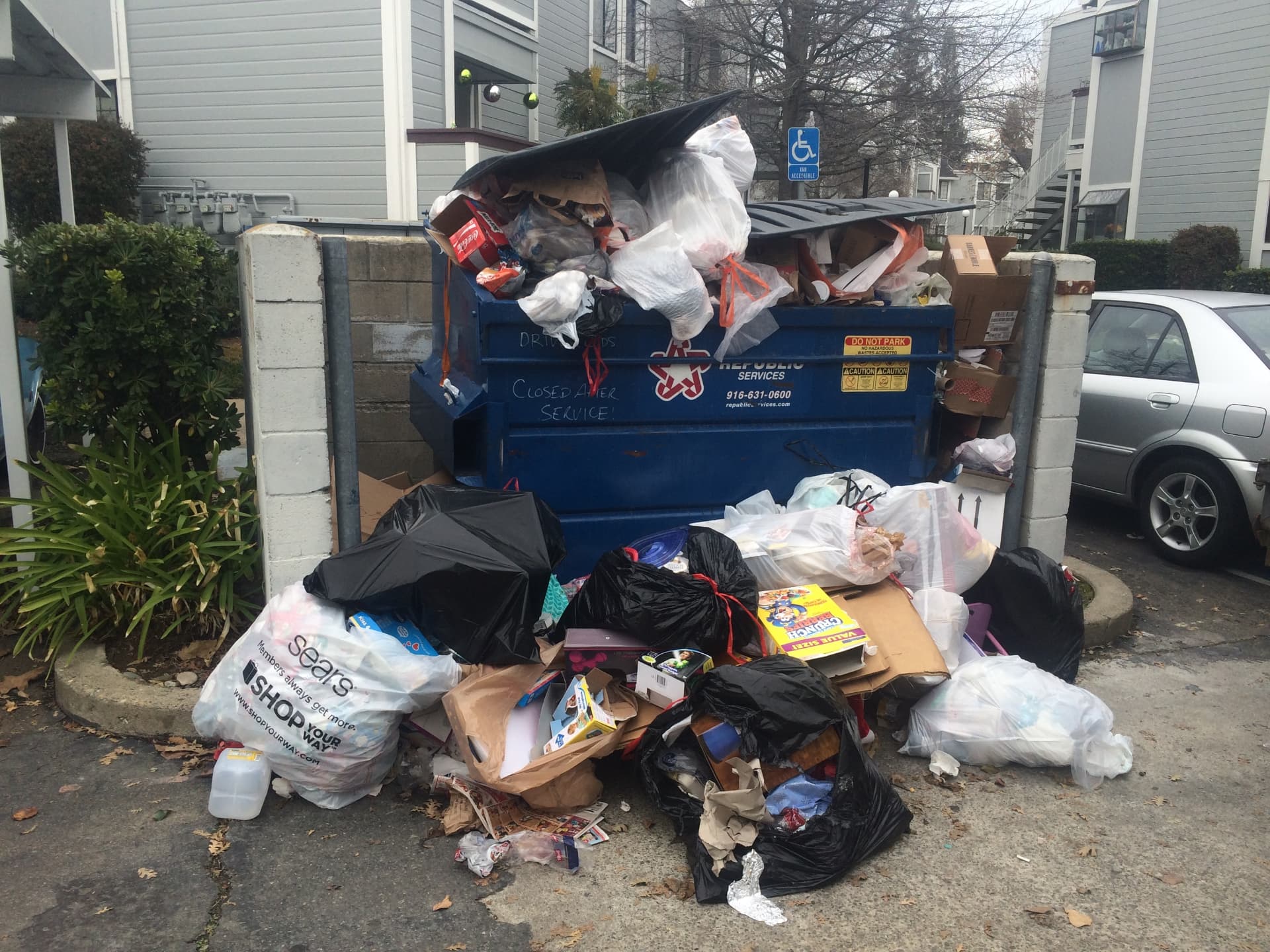 Apartment Dumpster Overflow before Long's Trash Hauling